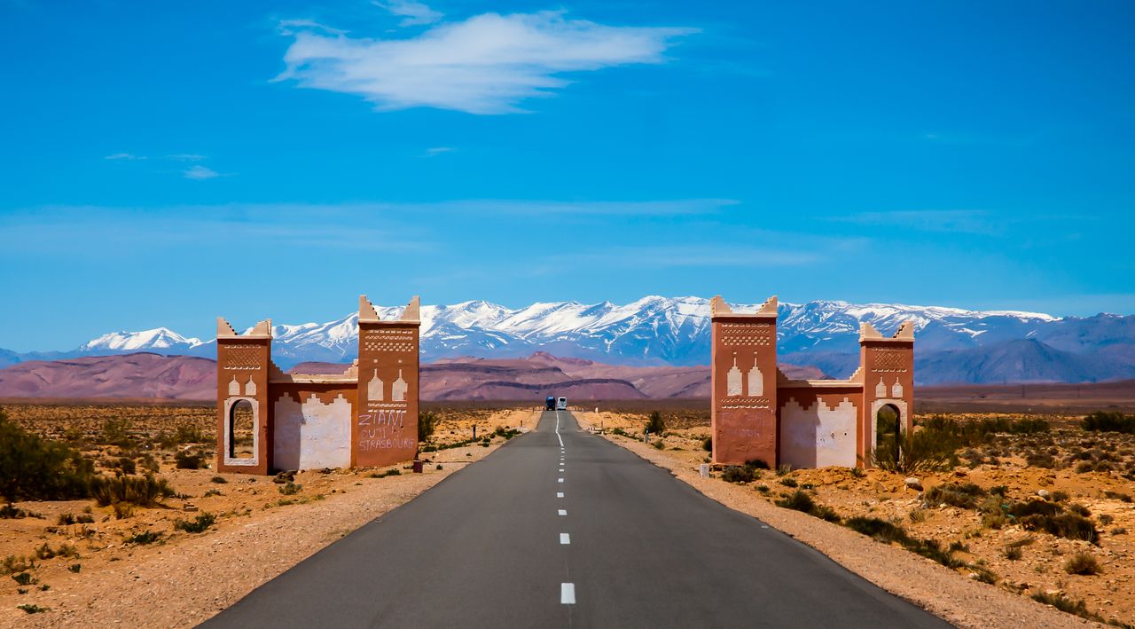 Home Explore the open road leading to Morocco's Atlas Mountains on a sunny day.