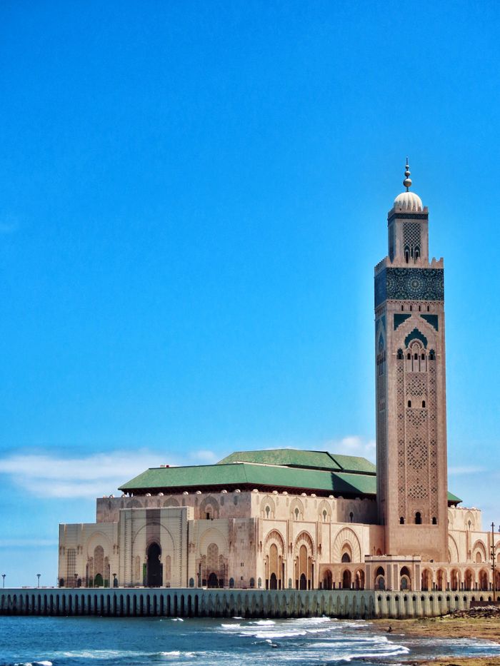 menu-01 Stunning view of Hassan II Mosque's minaret against the ocean in Casablanca, Morocco.