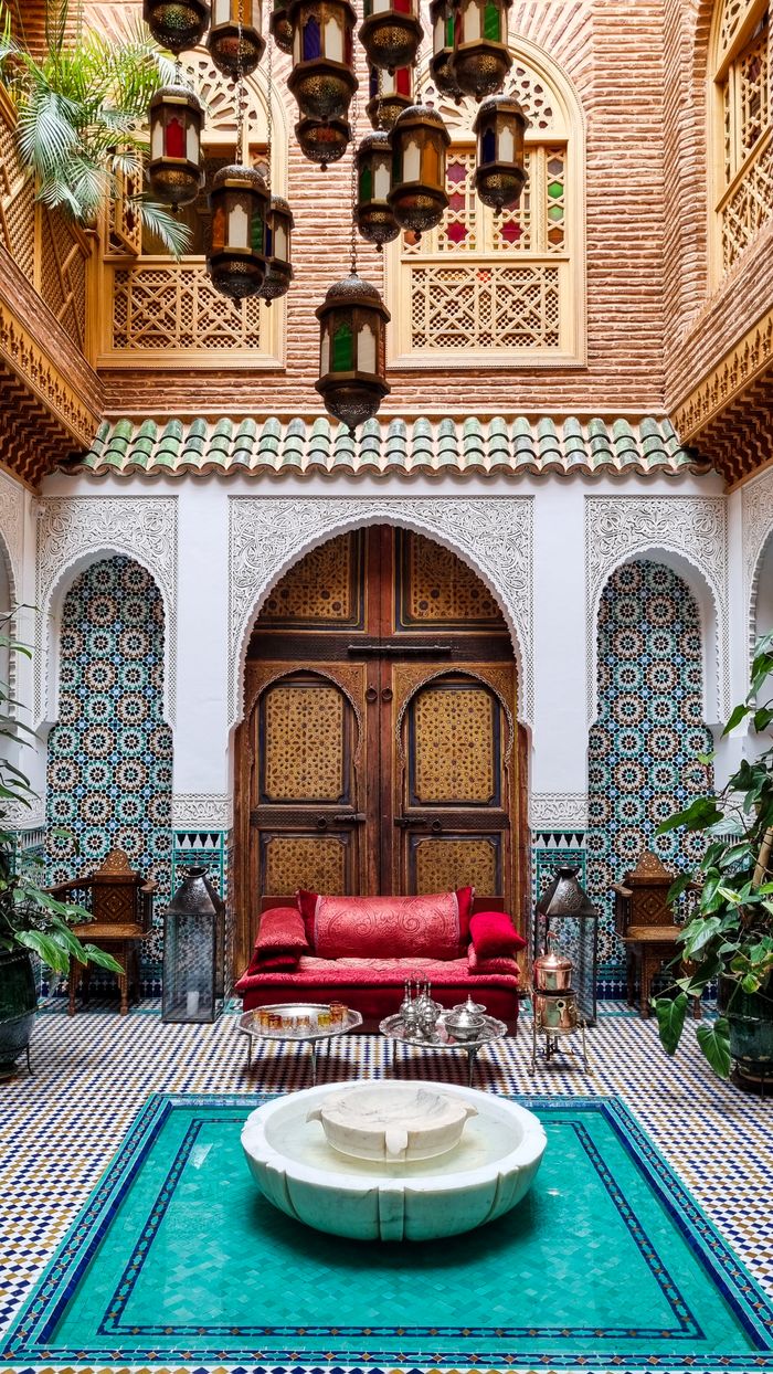 Home Stunning Moroccan riad courtyard with intricate tilework and central fountain.