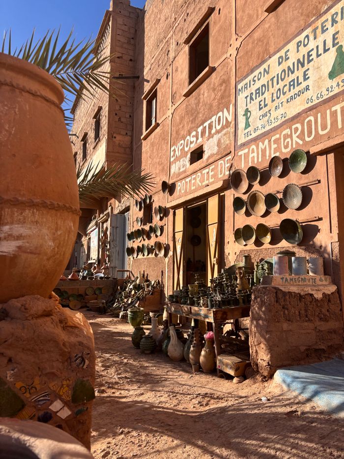 Home Explore the vibrant pottery market in Tamegroute, Morocco, showcasing traditional clay art.